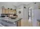 Cozy kitchen area with light wood cabinets, and seamless flow into the adjacent hallway at 8471 Secret Key Cv, Kissimmee, FL 34747