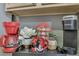 Close-up of a charming coffee station with Keurig and red coffee maker, enhancing the kitchen's appeal at 8471 Secret Key Cv, Kissimmee, FL 34747