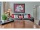A living room featuring a tile floor, neutral walls, a framed painting, and leather couches with decorative pillows at 8471 Secret Key Cv, Kissimmee, FL 34747