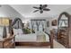 Spacious primary bedroom features tile flooring, large window, and an elegant, oversized, decorative wood bed frame at 8471 Secret Key Cv, Kissimmee, FL 34747