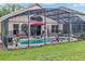 A screened-in pool offers space for outdoor relaxation and recreation with ample space for seating and leisure at 8471 Secret Key Cv, Kissimmee, FL 34747