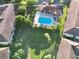 Overhead view of a sparkling community pool surrounded by lush landscaping and residential buildings at 8761 The Esplanade # 6, Orlando, FL 32836