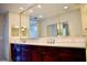 Bathroom with double vanity and framed mirror at 8761 The Esplanade # 6, Orlando, FL 32836