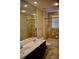 Elegant bathroom featuring a double sink vanity, tiled walls, and a bathtub for relaxation at 8761 The Esplanade # 6, Orlando, FL 32836