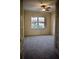 Bright, carpeted room with a ceiling fan and ample natural light from a window, perfect for a home office at 8761 The Esplanade # 6, Orlando, FL 32836