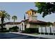 Exterior of the clubhouse with a beautiful tower in a community with manicured landscaping at 8761 The Esplanade # 6, Orlando, FL 32836