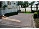 Paver driveway leading to waterfront property with palm trees at 8761 The Esplanade # 6, Orlando, FL 32836