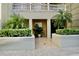 Exterior view of a private entrance framed with verdant plants and hedges at 8761 The Esplanade # 6, Orlando, FL 32836