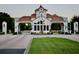 A gated community entrance with Mediterranean architecture, security, and manicured landscaping at 8761 The Esplanade # 6, Orlando, FL 32836