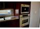 Gourmet kitchen featuring stainless steel appliances, granite countertops, and custom cabinetry at 8761 The Esplanade # 6, Orlando, FL 32836