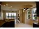 Bright and airy living room with lake views, neutral walls and a modern chandelier at 8761 The Esplanade # 6, Orlando, FL 32836