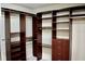 Organized walk-in closet with custom dark wood shelving and drawers, maximizing storage and adding sophistication at 8761 The Esplanade # 6, Orlando, FL 32836