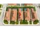 Aerial shot of townhome roofs, back patios, and shared pool amenities within the community at 9004 Majesty Palm Rd, Kissimmee, FL 34747