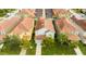 Overhead view of a two-story house with a terracotta-colored roof and manicured lawn at 9004 Majesty Palm Rd, Kissimmee, FL 34747