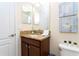 Bathroom features a vanity with granite countertop, a modern faucet, and white towels at 9004 Majesty Palm Rd, Kissimmee, FL 34747