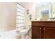 Bathroom features a shower/tub combo, toilet, and a vanity with dark cabinets at 9004 Majesty Palm Rd, Kissimmee, FL 34747