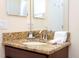 Modern bathroom vanity features a granite countertop, a sink with modern faucet, and white towels at 9004 Majesty Palm Rd, Kissimmee, FL 34747