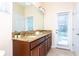 Bright bathroom with double vanity, granite counters, and direct access to the pool area at 9004 Majesty Palm Rd, Kissimmee, FL 34747