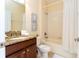 Bright bathroom featuring a shower/tub combo, granite countertop vanity and neutral color palette at 9004 Majesty Palm Rd, Kissimmee, FL 34747