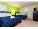 Bedroom with two twin beds, closet, and media cabinet at 9004 Majesty Palm Rd, Kissimmee, FL 34747