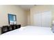 Comfortable bedroom with closet, television, and a cozy bed with fresh white linens and pillows at 9004 Majesty Palm Rd, Kissimmee, FL 34747