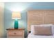 Well-lit bedroom featuring a wooden headboard and a turquoise lamp for a pop of color at 9004 Majesty Palm Rd, Kissimmee, FL 34747