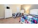 Bright bedroom features two beds with plaid bedding, a dresser, and a television at 9004 Majesty Palm Rd, Kissimmee, FL 34747