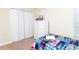 Bedroom showcases white closet doors, dresser and a bed with plaid bedding at 9004 Majesty Palm Rd, Kissimmee, FL 34747