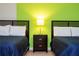 Twin beds feature dark wood frames and central nightstand at 9004 Majesty Palm Rd, Kissimmee, FL 34747