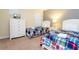 Bright bedroom features two beds with plaid bedding, a dresser, and a television at 9004 Majesty Palm Rd, Kissimmee, FL 34747