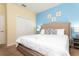 Bright bedroom featuring a large bed with decorative pillows, side tables, and a closet at 9004 Majesty Palm Rd, Kissimmee, FL 34747