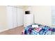 Bedroom showcases white closet doors, dresser and a bed with plaid bedding at 9004 Majesty Palm Rd, Kissimmee, FL 34747