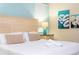 Comfortable bedroom showcasing queen bed with white linens and neutral-toned accents at 9004 Majesty Palm Rd, Kissimmee, FL 34747