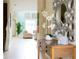 Bright entryway featuring a decorative mirror, console table with orchids, and views into the living area at 9004 Majesty Palm Rd, Kissimmee, FL 34747