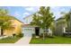 Charming two-story home with a well-maintained lawn and attached single car garage at 9004 Majesty Palm Rd, Kissimmee, FL 34747