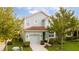 Quaint two-story home with manicured lawn, tidy shrubbery, and attached single car garage at 9004 Majesty Palm Rd, Kissimmee, FL 34747