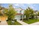 Two-story home with a well-maintained lawn, simple shrubbery, and attached single car garage at 9004 Majesty Palm Rd, Kissimmee, FL 34747
