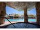 Relaxing hot tub near the pool with a rock structure providing a waterfall feature at 9004 Majesty Palm Rd, Kissimmee, FL 34747