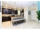 Kitchen with dark wood cabinets, granite countertops, and stainless steel appliances at 9004 Majesty Palm Rd, Kissimmee, FL 34747