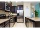 Kitchen with dark wood cabinets, stainless steel appliances, and granite countertops at 9004 Majesty Palm Rd, Kissimmee, FL 34747
