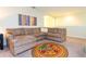 Comfortable living area with a sectional sofa, colorful rug, and bright, natural light at 9004 Majesty Palm Rd, Kissimmee, FL 34747