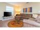 Cozy living room featuring a plush sectional sofa and vibrant, colorful accent rug at 9004 Majesty Palm Rd, Kissimmee, FL 34747