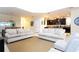 Open concept floor plan with two sofas, seamlessly flows into kitchen at 9004 Majesty Palm Rd, Kissimmee, FL 34747