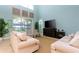 Bright living room features a sliding glass door and comfortable seating at 9004 Majesty Palm Rd, Kissimmee, FL 34747