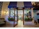 Entrance to market cafe with awning; plants adorn the entrance of this small retail space at 9004 Majesty Palm Rd, Kissimmee, FL 34747