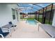 Outdoor living features a private screened-in pool and spa area, perfect for relaxation and entertainment at 9004 Majesty Palm Rd, Kissimmee, FL 34747