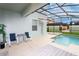 Outdoor living features a private screened-in pool and spa area, perfect for relaxation and entertainment at 9004 Majesty Palm Rd, Kissimmee, FL 34747