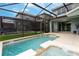 Private screened-in pool and spa area offers a refreshing escape with lush green landscaping and serene privacy at 9004 Majesty Palm Rd, Kissimmee, FL 34747