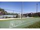 Shuffleboard court surrounded by a chain link fence and palm trees at 9004 Majesty Palm Rd, Kissimmee, FL 34747