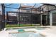 Private in-ground spa featuring a tiled border and screened enclosure with a view of the backyard at 9004 Majesty Palm Rd, Kissimmee, FL 34747